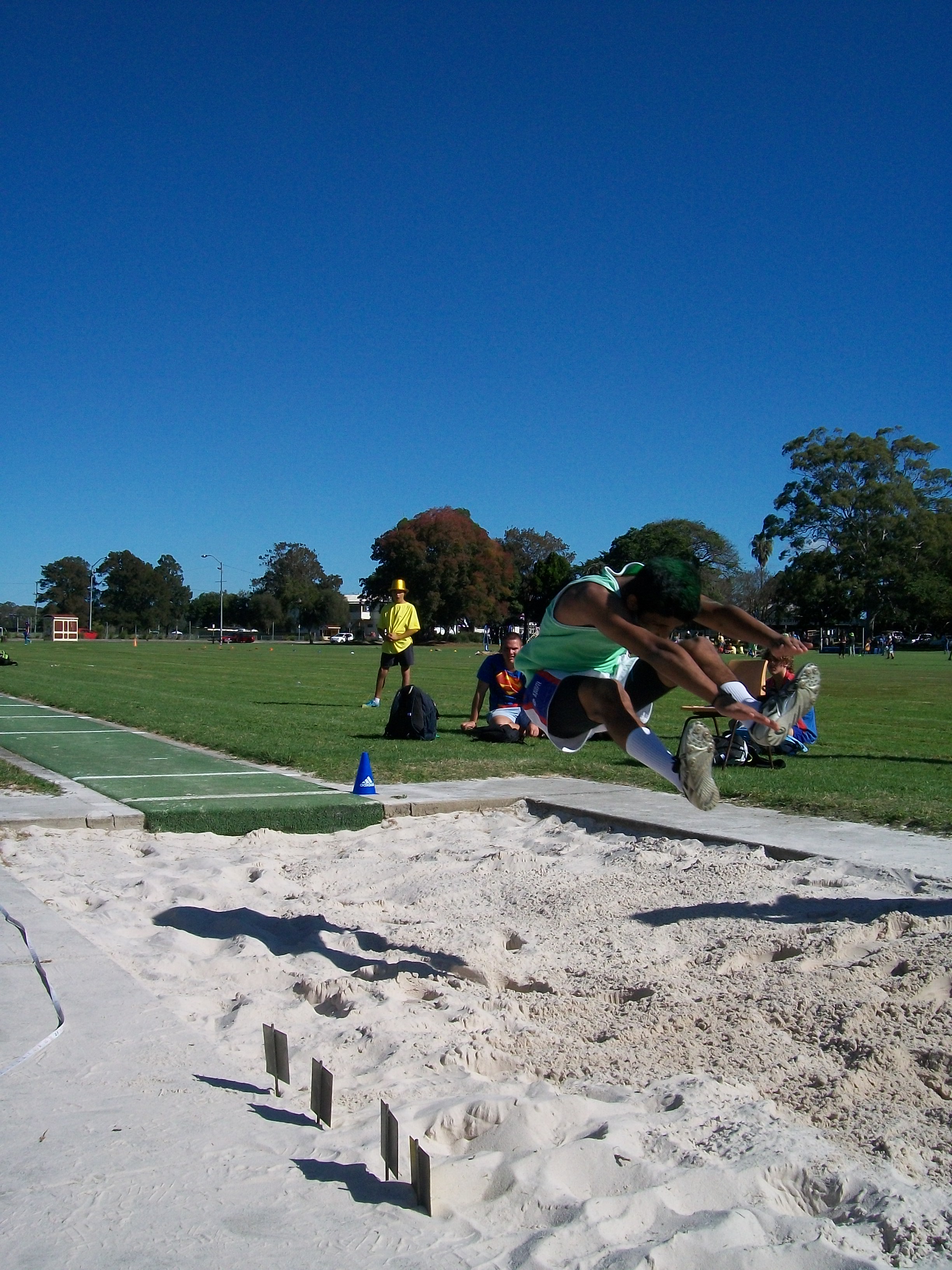 Ali puts his all into the long jump.